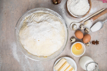 Beat flour and kitchen utensils, a baking dish, a rolling pin with eggs on the table. Baking, cooking concept. Chef making bread and gingerbread cookies. The cook kneads and rolls the dough.