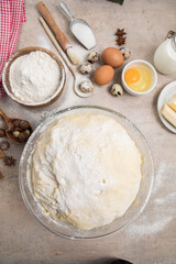 Beat flour and kitchen utensils, a baking dish, a rolling pin with eggs on the table. Baking, cooking concept. Chef making bread and gingerbread cookies. The cook kneads and rolls the dough.
