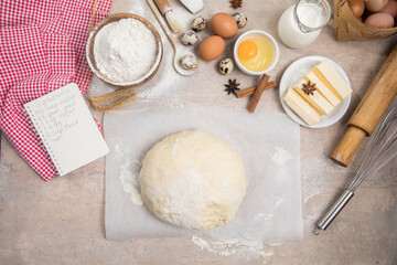 Beat flour and kitchen utensils, a baking dish, a rolling pin with eggs on the table. Baking, cooking concept. Chef making bread and gingerbread cookies. The cook kneads and rolls the dough.