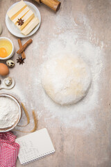 Beat flour and kitchen utensils, a baking dish, a rolling pin with eggs on the table. Baking, cooking concept. Chef making bread and gingerbread cookies. The cook kneads and rolls the dough.