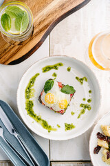 Smorrebrod, Danish open sandwich with salmon, egg, avocado and cilantro sauce. Top view