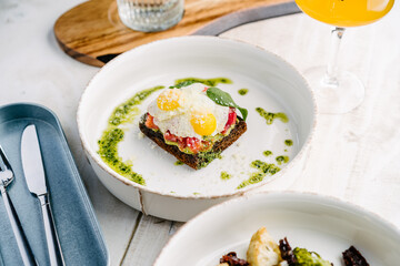 Smorrebrod, Danish open sandwich with salmon, egg, avocado and cilantro sauce