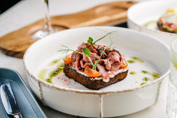 Smorrebrod, Danish open sandwich with roast beef, sweet onion and cherry tomato