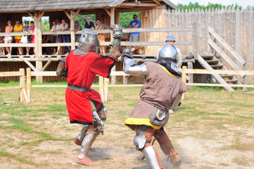Kyiv, Ukraine. July 06, 2013. Two medieval knights fighting in sword armor, a show tournament at...