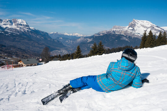 Skier sitting in the slope watching a beautiful landscape in Chamonix & Mont Blanc ski area