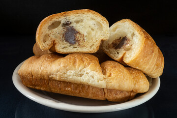 Croissants in a white plate on the table