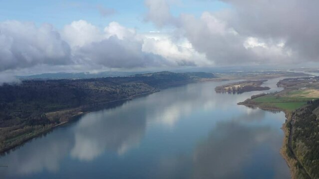 Low clouds drift over the Columbia River which runs between Oregon and Washington. The scenic Columbia River Gorge, with the Columbia River flowing through it, is over 80 miles long.