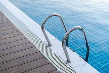 Stainless steel ladder for use from the swimming pool. © mrklong