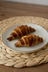 Delicious homemade croissants on a plate.