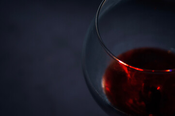 Red wine glass closeup photography on dark background