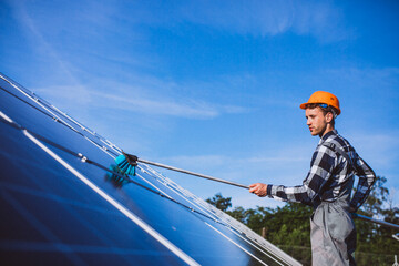 Man worker in the firld by the solar panels