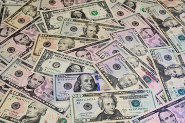 Banknotes of US dollars of different denominations arranged in random order