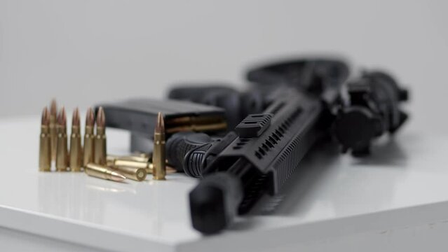 Black iron modern army military machine gun and cartridges, small arms for soldiers with an optical sight lie on a white background. Close-up