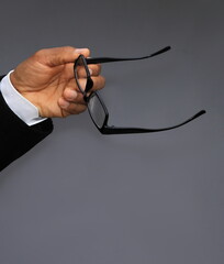 man with reading glasses in his hand stock photo