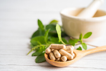 Alternative medicine herbal organic capsule drug with herbs leaf natural supplements for healthy good life.