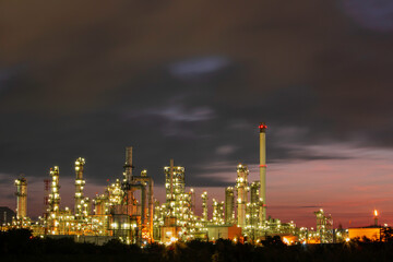 Fototapeta na wymiar Oil​ refinery​ and​ plant and tower column of Petrochemistry industry in pipeline oil​ and​ gas​ ​industry with​ cloud​ slowing red sky