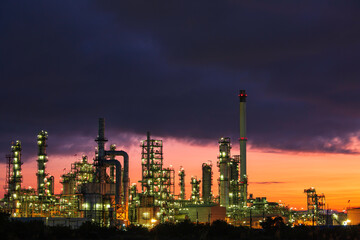 Fototapeta na wymiar Oil​ refinery​ and​ plant and tower column of petrochemistry industry in pipeline oil​ and​ gas​ ​industry with​ sun red sky the morning