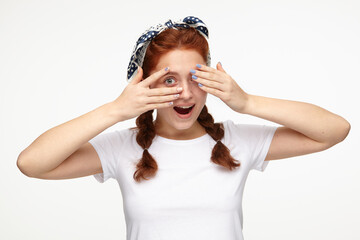 Indoor portrait of young ginger female posing over white background flirts with new boyfriend