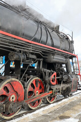 Naklejka premium retro steam lococmotive in the winter on the station