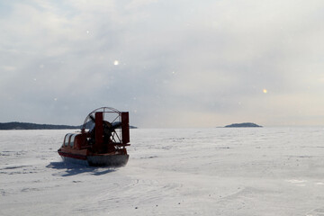snowmobile on the ice of the frozen lake in sunny day