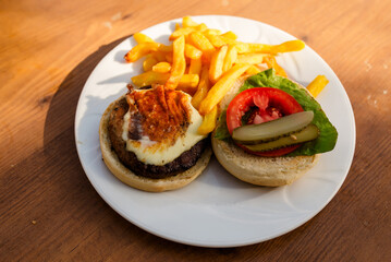 Sandwich with ham and french fries on a beach