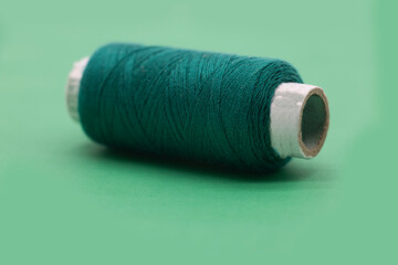 single dark Cyan color yarn or spool thread over on background