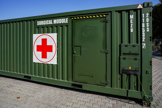 Brno, Czechia - October 08, 2021: Green metal army container box - Surgical module - with red cross, setup as field ambulance demonstration during IDET military and defence exhibition fair