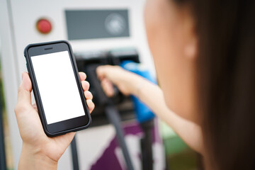 Empty screen of mockup smartphone isolated with clipping path. Asian young woman using ev charging application on smartphone.
