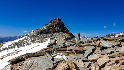 Woman hiking to the Zittelhaus in the summit of mount Hoher Sonnblick in the High Tauern mountains...