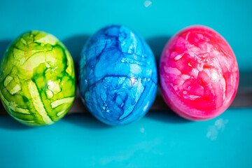 3 easter eggs on aquamarine background, happy, colorful easter,