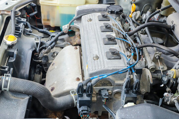 Fototapeta premium Old dirty engine under the hood of a car close-up