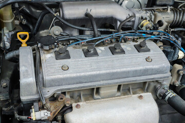 Old dirty engine under the hood of a car close-up