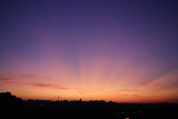 foto of beautiful sunset sky above city silhouette