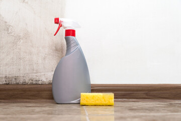 Close-up of a yellow sponge, cleansing antifungal agent fighting mold in an apartment against a...