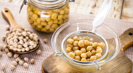 chickpeas being sieved to extract aquafaba, cooking liquid used as an alternative to egg whites