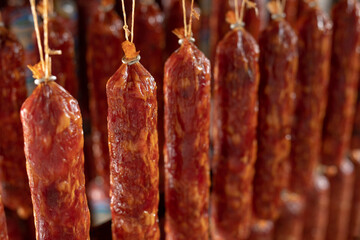 Factory for the production of meat products, cured sausages. Traditional spicy sausage hanging to...