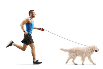 Full length profile shot of a man jogging with a retreiver dog - Powered by Adobe