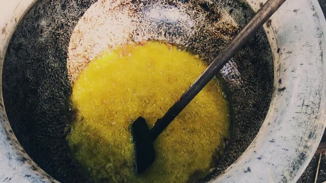 Garlic onion and different masala frying in deep mustard oil in a mega kitchen.Chef's cooking in mega kitchen.