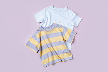 Childrens T-shirts on pink background. Set of baby clothes  for spring, autumn or summer. Fashion...