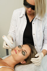 Woman client during IPL treatment in a cosmetology clinic