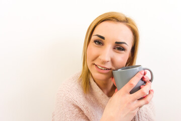 Portrait of happy woman holding a mug isolated on white background