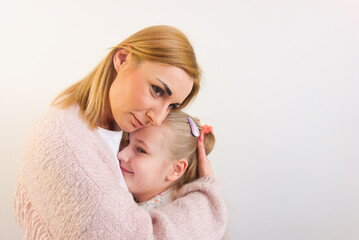 Woman hugging her cute little daughter isolated on white background. Mother's love, International Children's Day concepts