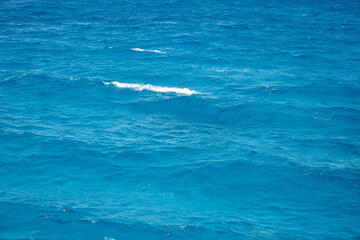 Abstract background. Waves of blue sea water. Copy space. Selective focus.
