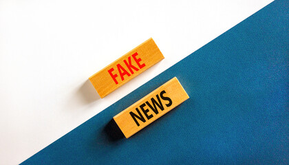 Fake news symbol. Wooden blocks with concept words Fake news on beautiful white and blue background. Business media and fake news concept. Copy space.