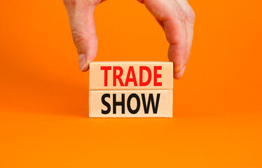 Trade show symbol. Wooden blocks with concept words Trade show on beautiful orange background....