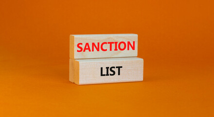 Sanction list symbol. Wooden blocks with concept words Sanction list on beautiful orange background. Business political sanction list concept. Copy space.