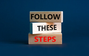 Follow these steps symbol. Concept words Follow these steps on wooden blocks. Beautiful grey background. Business and follow these steps concept. Copy space.