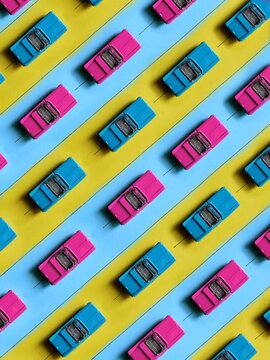 Pattern of colorful vintage children's cars on a blue and yellow road. Background of groovy toy retro cars in style 70s.