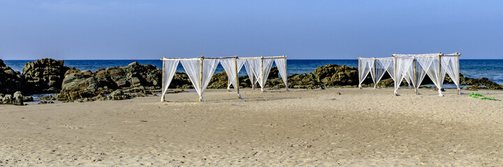 White canopies on a sandy beach