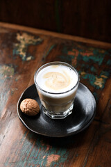 Coffee with milk on rustic wooden background. Soft focus. Close up. Copy space.	